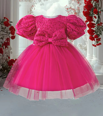 Pink sequin princess dress with puff sleeves, bow, tulle skirt, and back zip for girls.